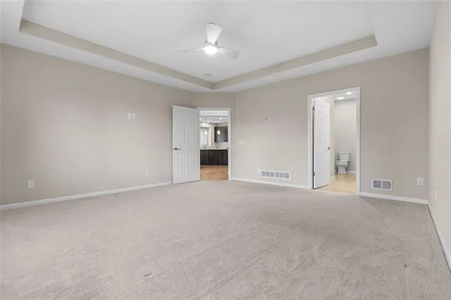a view of an empty room with a ceiling fan