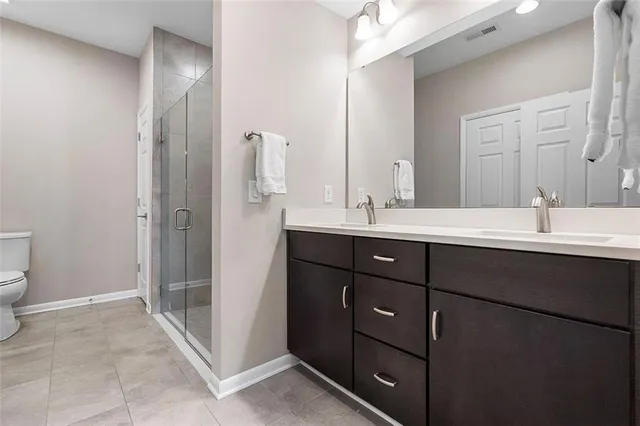 a bathroom with a double vanity sink and mirror