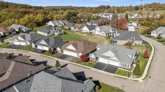 an aerial view of residential houses with outdoor space