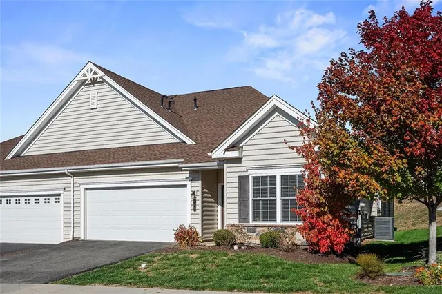 a view of a house with a yard and potted plants