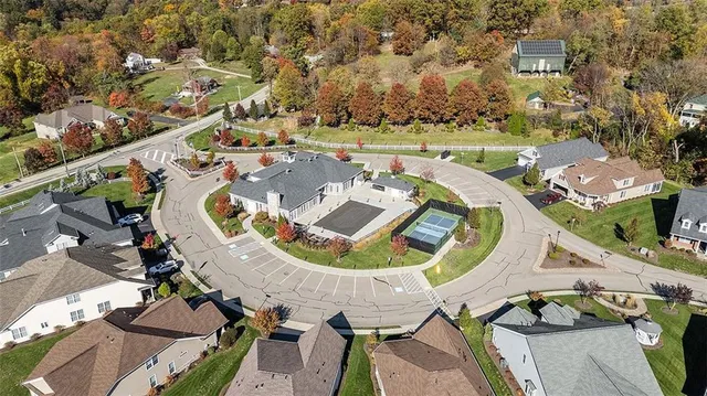 an aerial view of a house with outdoor space and swimming pool