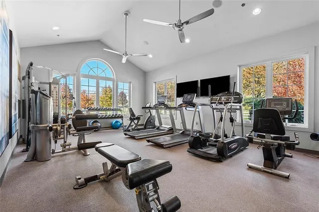 a view of a livingroom with workspace and a window