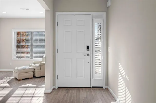 a view of a bedroom with a window and wooden floor