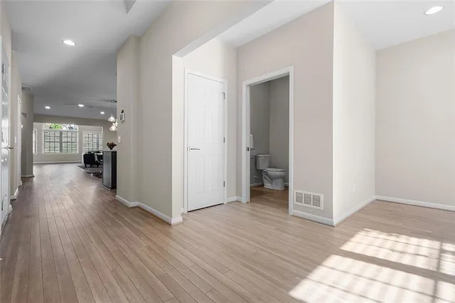 a view of a hallway with wooden floor