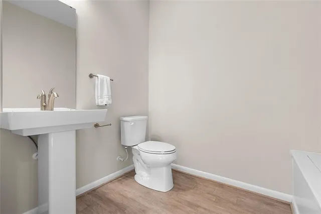 a bathroom with a sink toilet and a mirror