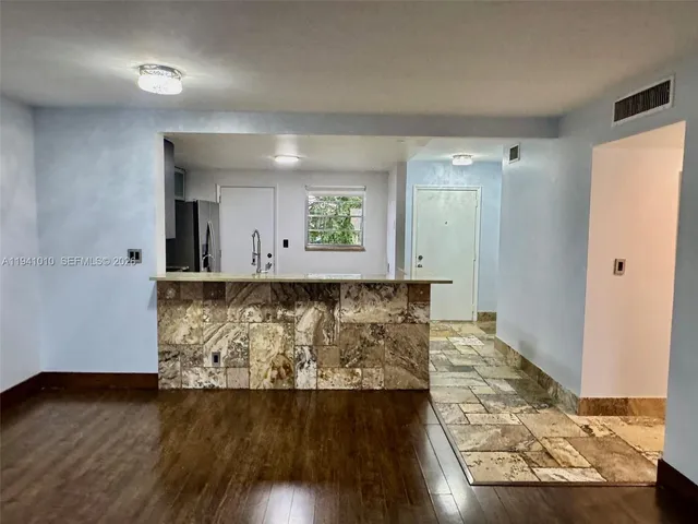 wooden floor with view of bathroom