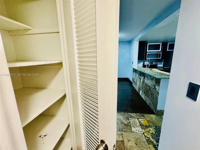 a view of a hallway with wooden floor and entryway
