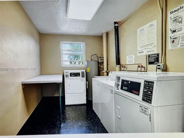 a kitchen with a stove cabinets and wooden floor
