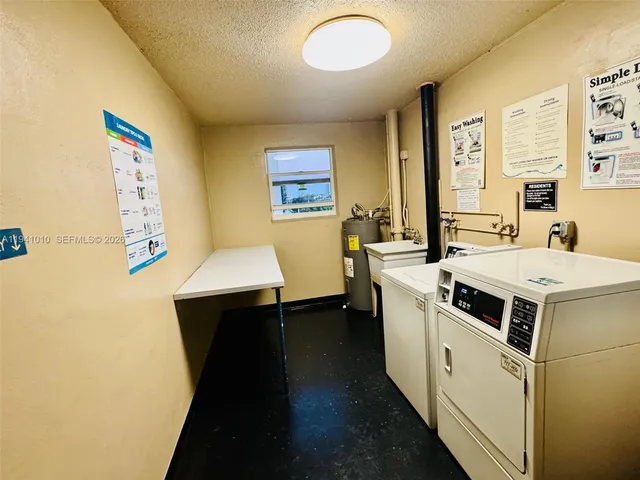 a utility room with a sink a washer and dryer