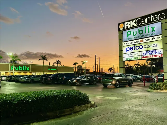 a view of a swimming pool with a yard and palm trees