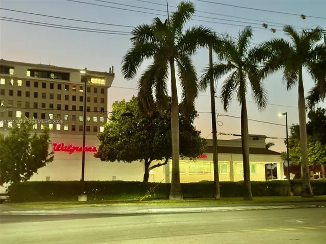 a view of a patio with table and chairs with wooden fence and plants