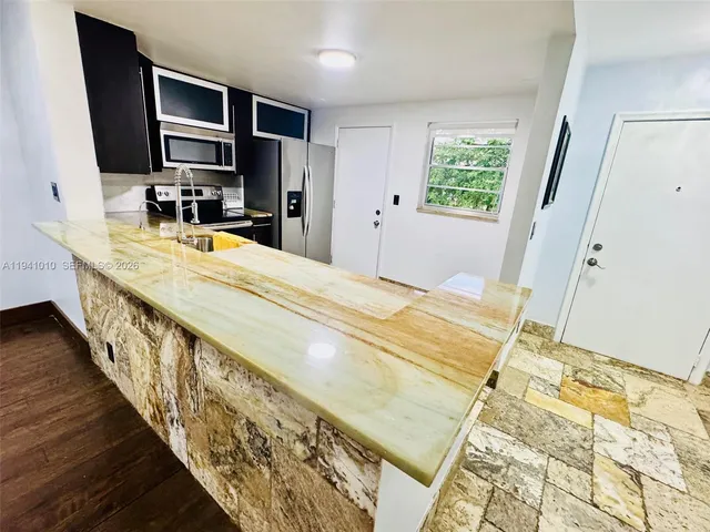 a bathroom with a double vanity sink and a large mirror