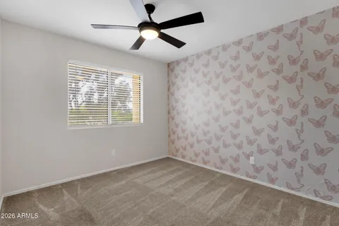 a view of empty room with ceiling fan