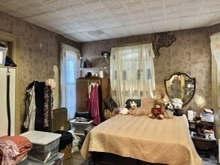 495 Warren Street Boston, MA 02121 - Photo 11 of 25 a bed room with a bed mirror and a table
