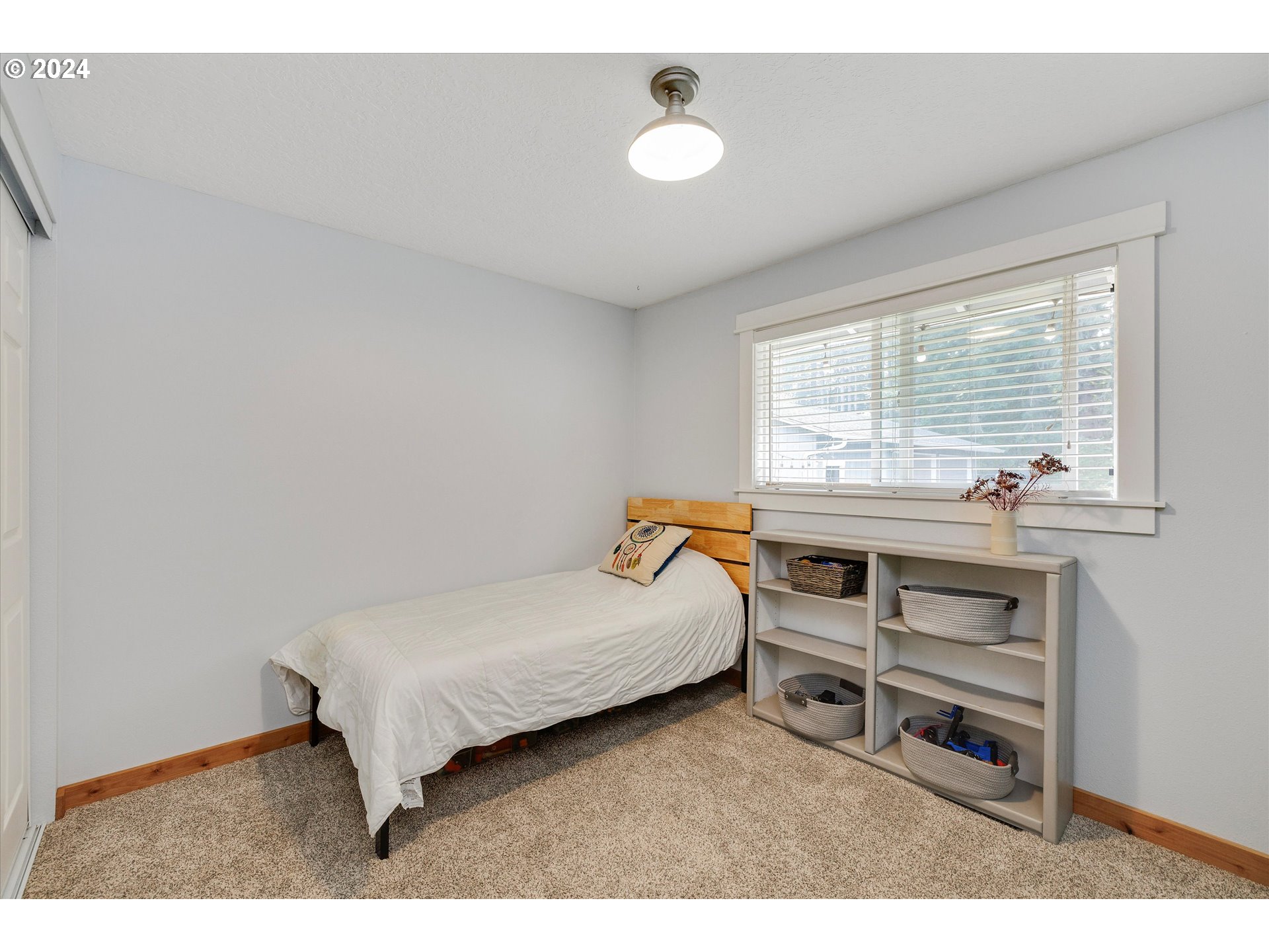 8431 Southeast Groce Road Corbett, OR 97019 - Photo 14 of 37 a bedroom with a bed and a large window