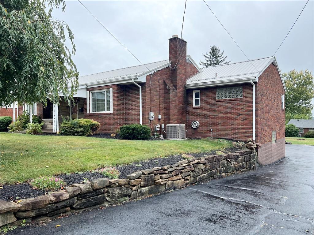 233 Reed Street Lower Burrell, PA 15068 - Photo 31 of 40 Side view and paved driveway. Newly installed a/c.