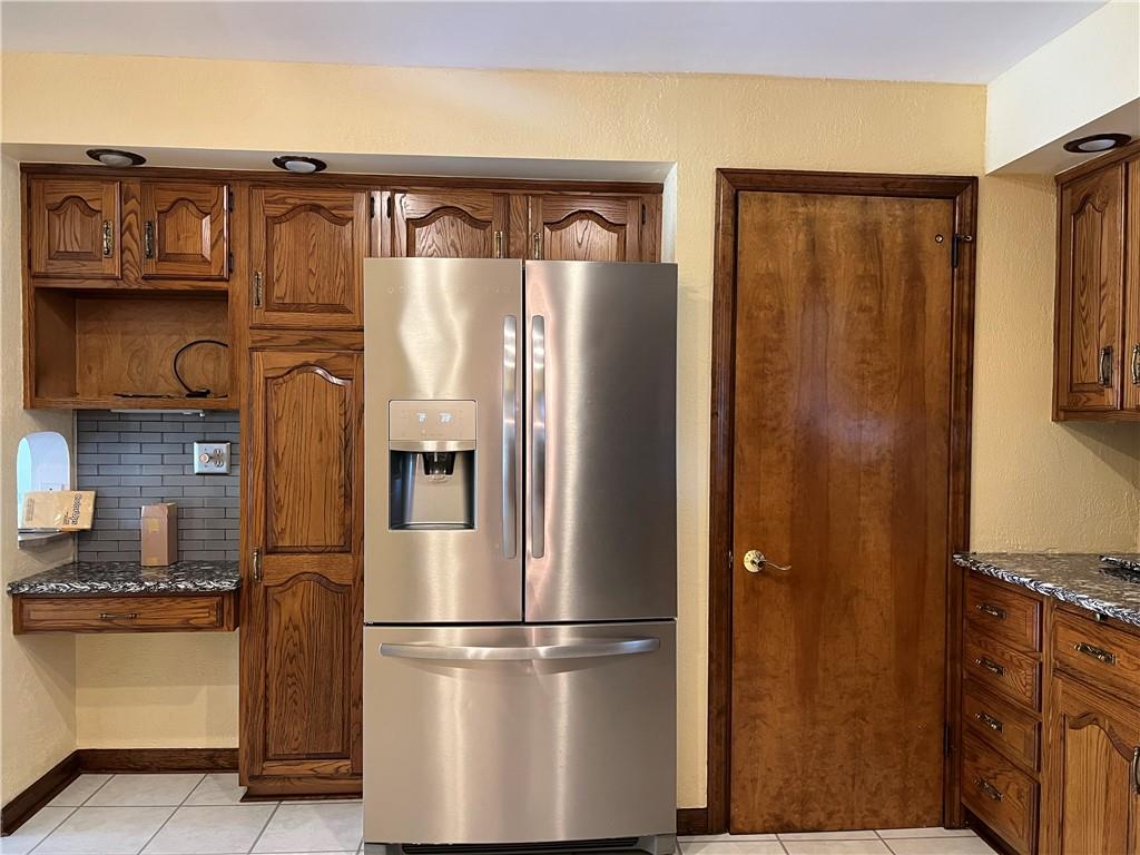 233 Reed Street Lower Burrell, PA 15068 - Photo 4 of 40 Stainless steel refrigerator. Door access to sun room and game room.