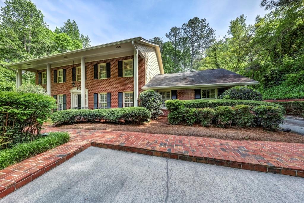 560 River Valley Road Northwest Sandy Springs, GA 30328 - Photo 1 of 1 a front view of a house with a yard