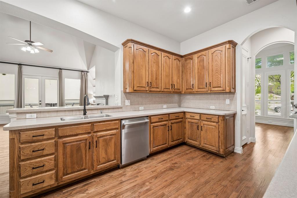 3309 Ricci Lane Irving, TX 75062 - Photo 12 of 36 Kitchen with hardwood floors, new dishwasher, oak cabinets