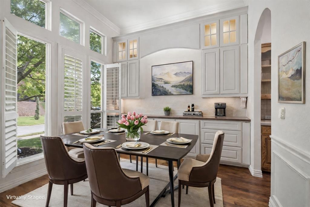 3309 Ricci Lane Irving, TX 75062 - Photo 3 of 36 Dining room with built-in lighted cabinets with buffet for serving. Wainscoting, plantation shutters and hardwood floors make this an elegant room for your entertianing pleasure.