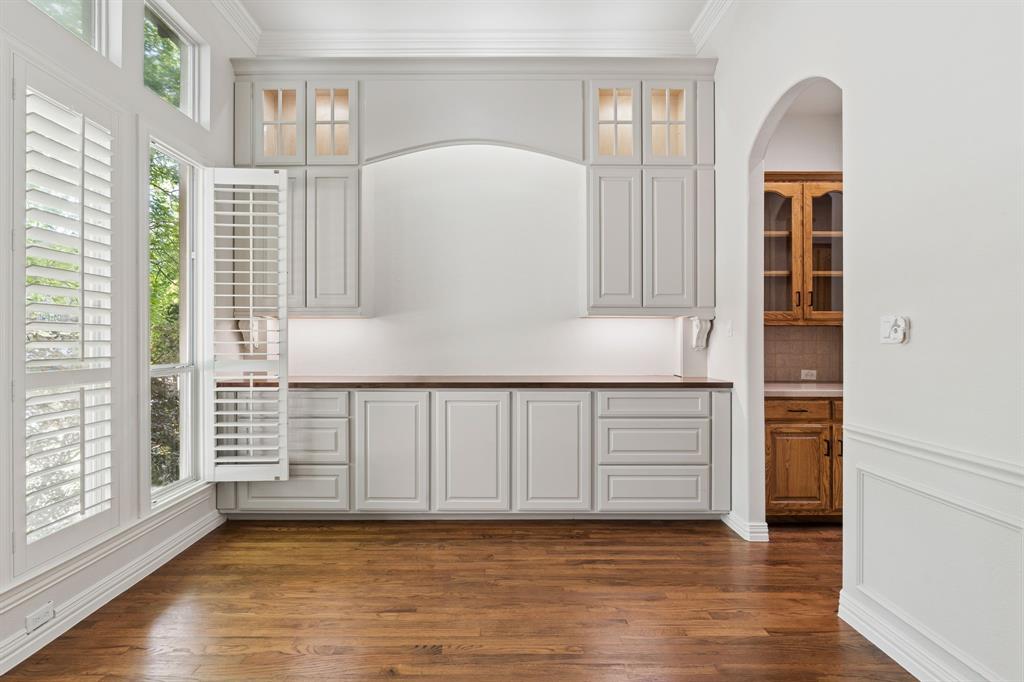 3309 Ricci Lane Irving, TX 75062 - Photo 5 of 36 Unfurnished dining area featuring ornamental molding and hardwood floors