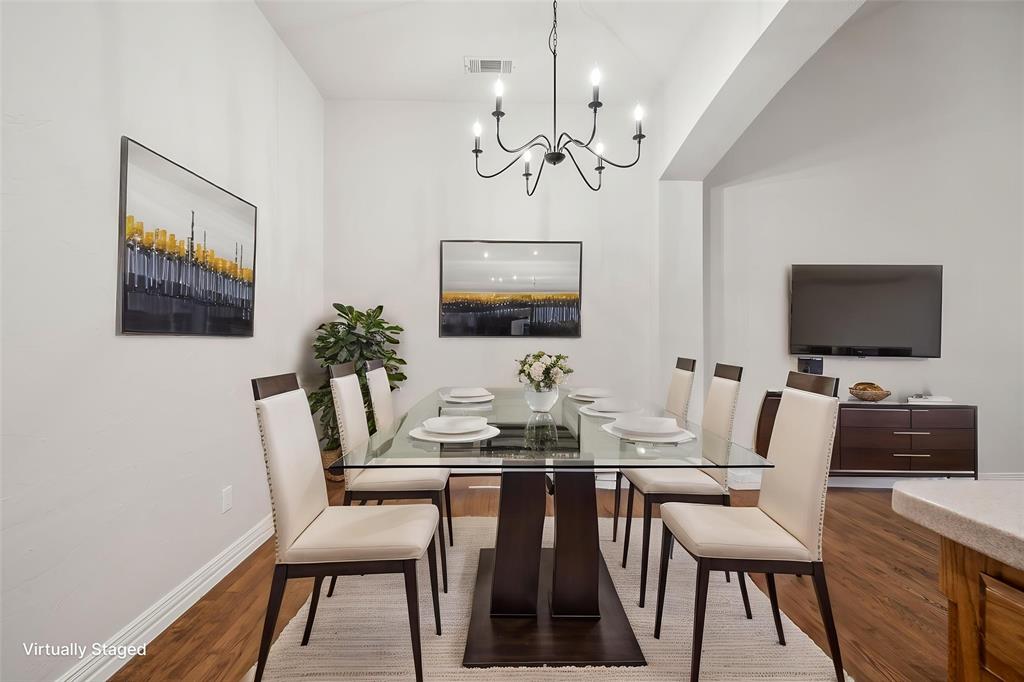 3309 Ricci Lane Irving, TX 75062 - Photo 10 of 36 Breakfast space featuring hardwood floors and a chandelier