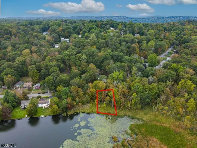 an aerial view of a houses with a yard