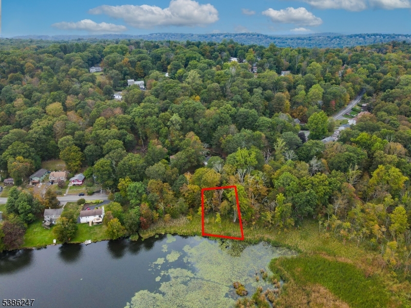 an aerial view of a houses with a yard