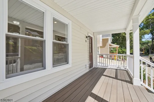a view of a balcony with wooden floor