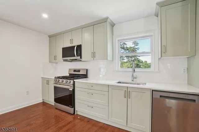 a kitchen with a sink stove and microwave
