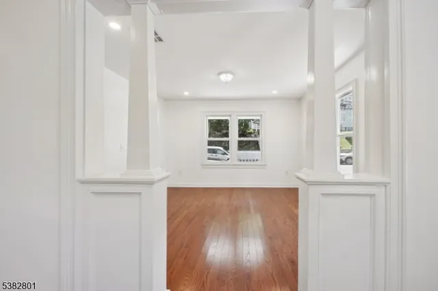 an entryway with wooden floor and cabinet