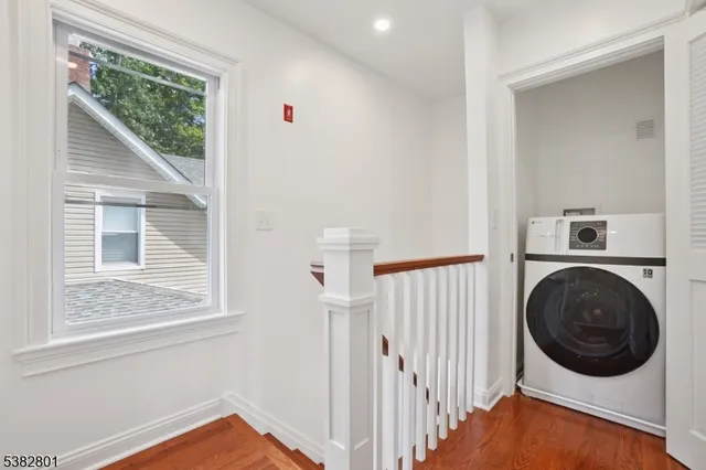 a view of a hallway with washer and dryer