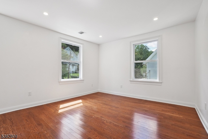 75 Chestnut Street Morristown, NJ 07960 - Photo 9 of 16 a view of empty room with wooden floor and fan