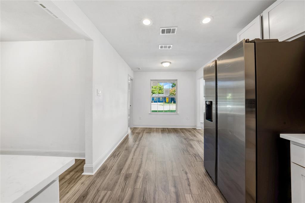 1608 Wynn Terrace Arlington, TX 76010 - Photo 11 of 28 a view of a refrigerator in kitchen and wooden floor