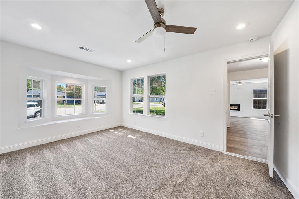 1608 Wynn Terrace Arlington, TX 76010 - Photo 12 of 28 a view of an empty room with a window and wooden floor