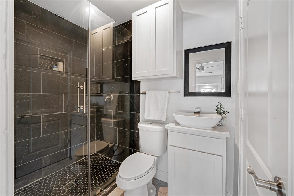 1608 Wynn Terrace Arlington, TX 76010 - Photo 15 of 28 a bathroom with a toilet sink and shower