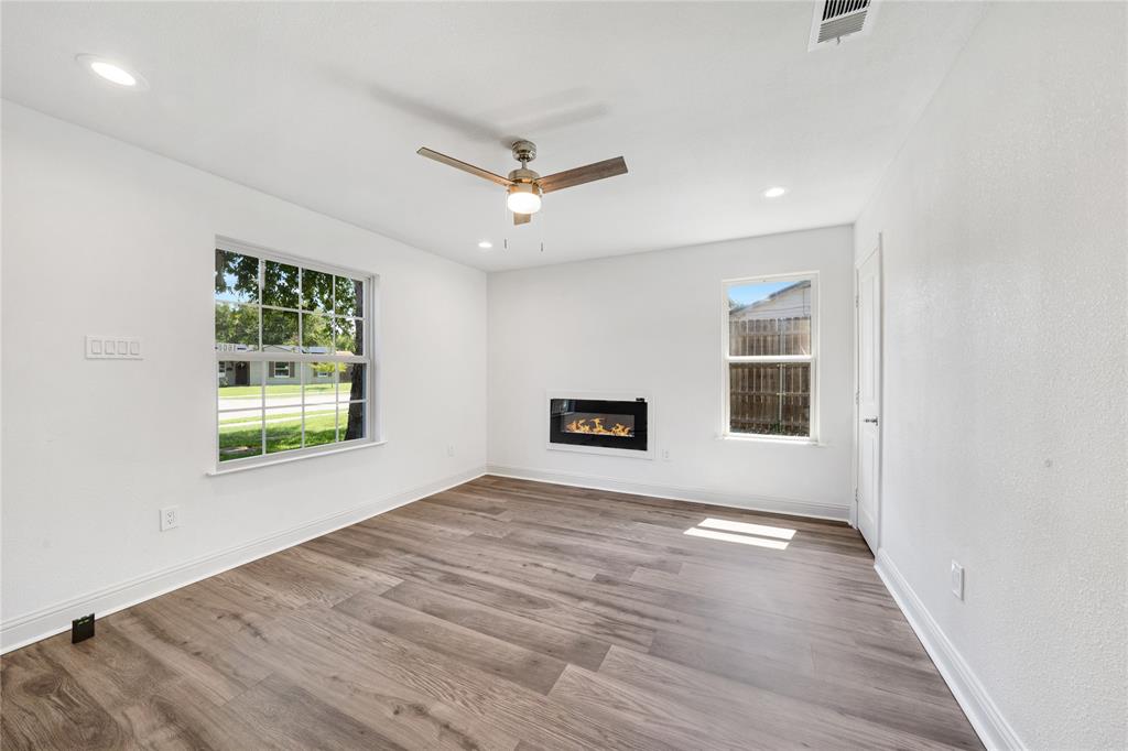 1608 Wynn Terrace Arlington, TX 76010 - Photo 2 of 28 a view of an empty room with a window and wooden floor