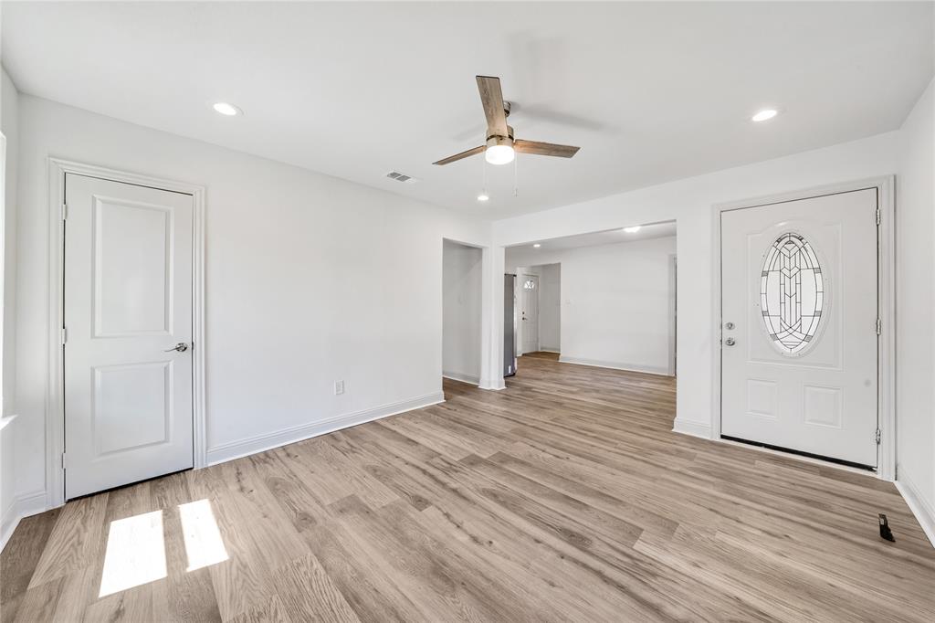 1608 Wynn Terrace Arlington, TX 76010 - Photo 5 of 28 wooden floor in an empty room with a window