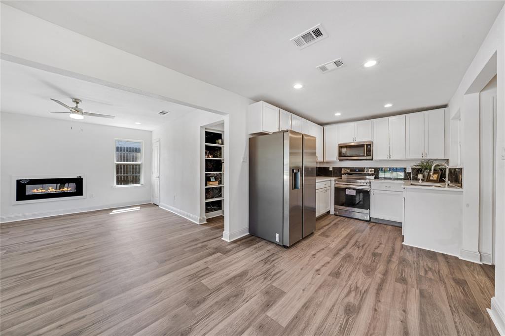 1608 Wynn Terrace Arlington, TX 76010 - Photo 6 of 28 a kitchen with stainless steel appliances granite countertop a refrigerator and a stove top oven