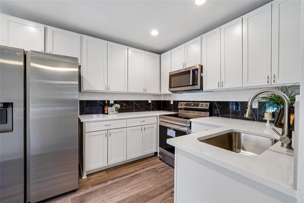 1608 Wynn Terrace Arlington, TX 76010 - Photo 9 of 28 a kitchen with a refrigerator sink and cabinets