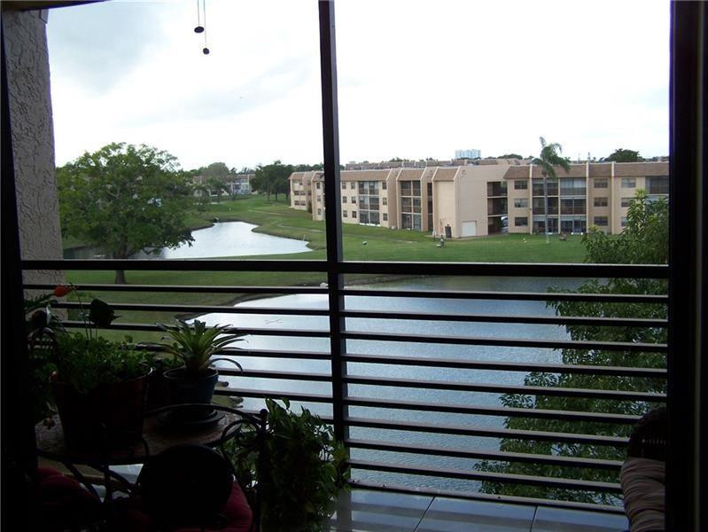 2981 North Nob Hill Road, Unit 406 Sunrise, FL 33322 - Photo 12 of 24 a view of a balcony with a yard