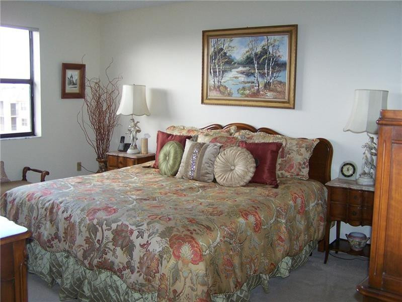 2981 North Nob Hill Road, Unit 406 Sunrise, FL 33322 - Photo 14 of 24 a bedroom with a bed and a painting on the wall