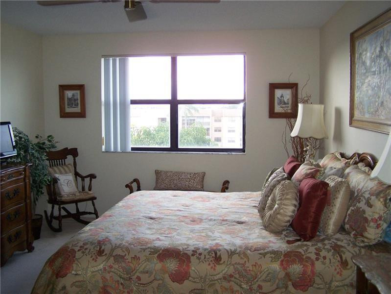 2981 North Nob Hill Road, Unit 406 Sunrise, FL 33322 - Photo 15 of 24 a bedroom with a bed and a window