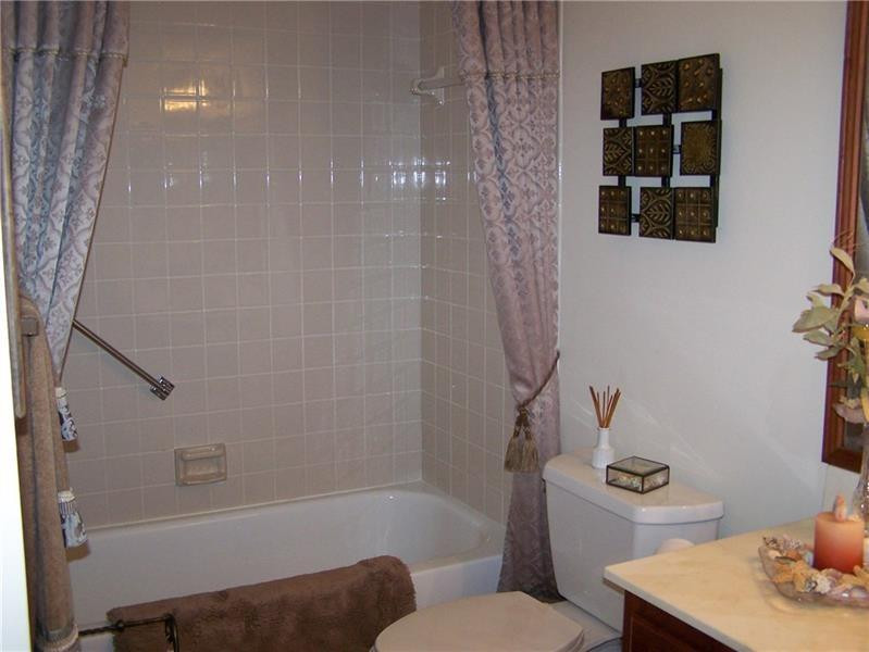 2981 North Nob Hill Road, Unit 406 Sunrise, FL 33322 - Photo 18 of 24 a bathroom with a bathtub shower sink vanity and toilet