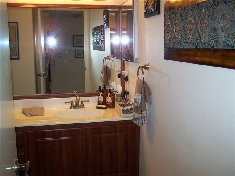 2981 North Nob Hill Road, Unit 406 Sunrise, FL 33322 - Photo 19 of 24 a bathroom with a sink and a mirror