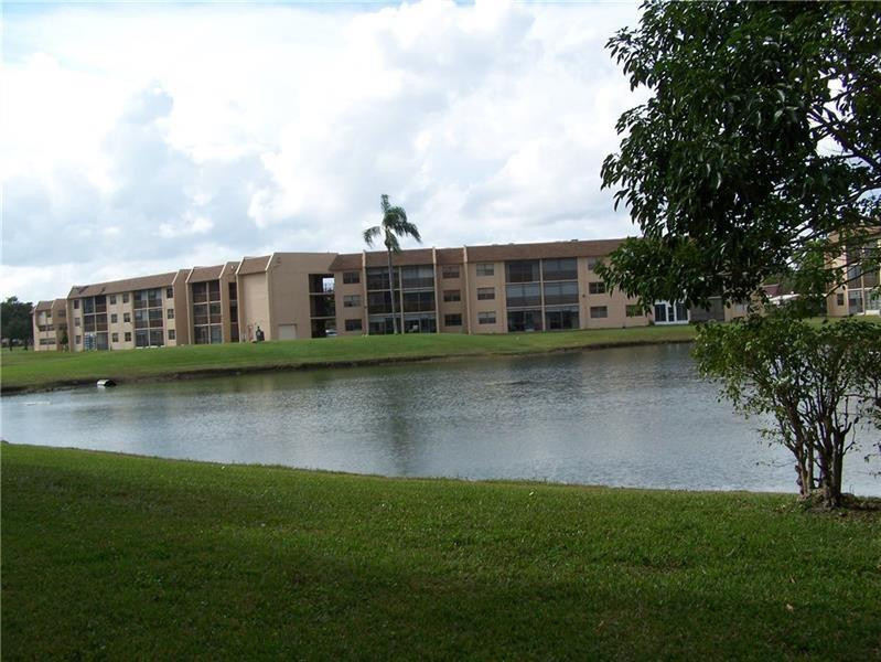 2981 North Nob Hill Road, Unit 406 Sunrise, FL 33322 - Photo 22 of 24 a view of a house with a yard from a lake view