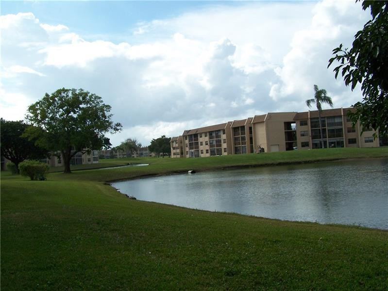 2981 North Nob Hill Road, Unit 406 Sunrise, FL 33322 - Photo 23 of 24 a view of building with river in front of it