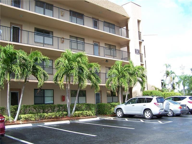 2981 North Nob Hill Road, Unit 406 Sunrise, FL 33322 - Photo 3 of 24 a view of street with parked cars