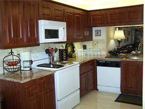 2981 North Nob Hill Road, Unit 406 Sunrise, FL 33322 - Photo 4 of 24 a kitchen with stainless steel appliances granite countertop a sink stove and cabinets