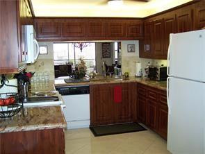 2981 North Nob Hill Road, Unit 406 Sunrise, FL 33322 - Photo 5 of 24 a kitchen with a refrigerator and a sink